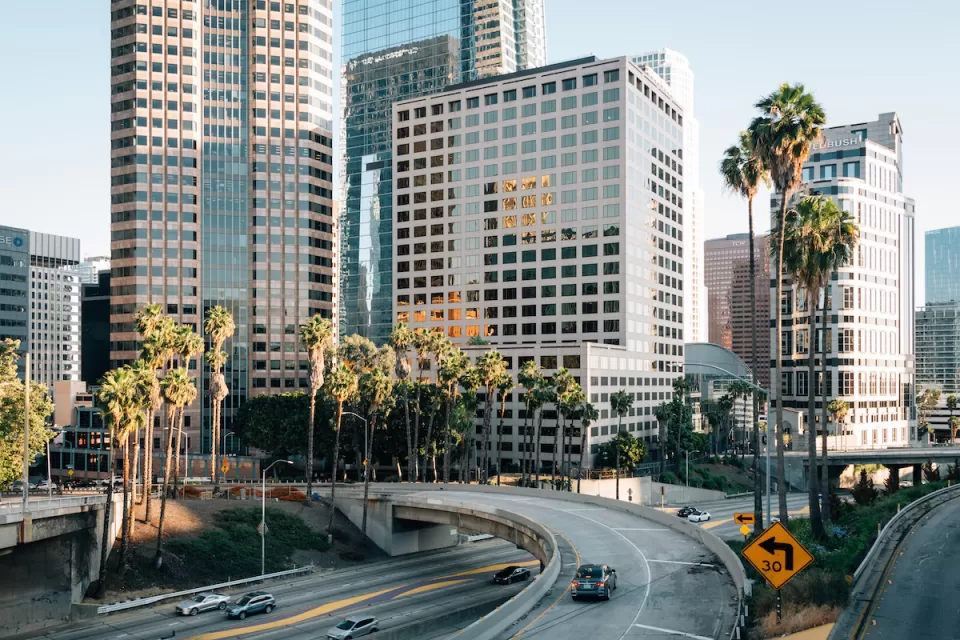 View of 110 freeway with downtown Los Angeles buildings in background.